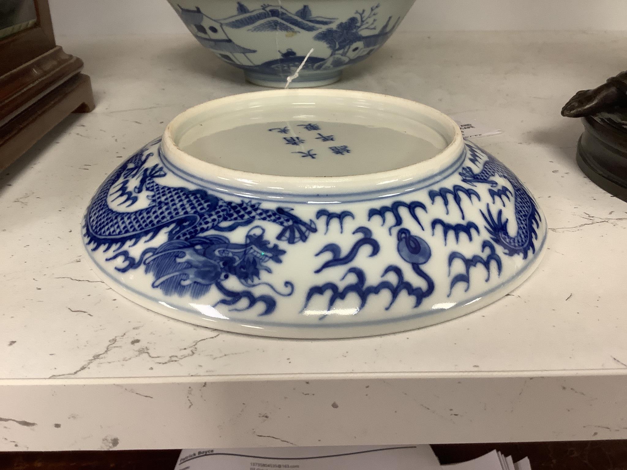 A Chinese blue and white landscape bowl, a/f and a Chinese blue and white ‘dragon’ dish, 18 and 16.5 cm